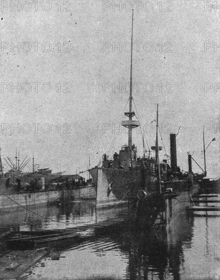 'Relevement du "Medjidie" a Odessa : le croiseur est soutenu par des chalands, et des..., c1915. Creator: Unknown.