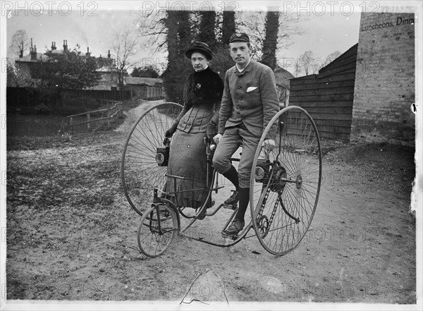 Man and a woman sitting on a double tricycle, England, c1890. Creator: Unknown.