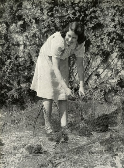'At Work in Her Garden - Windsor, 1941', 1947. Creator: Unknown.