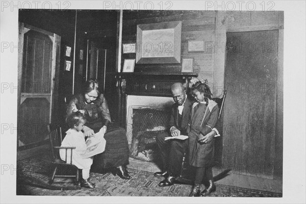 An African American family; Reading books, 1922. Creator: Unknown.