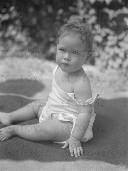 Nadelman baby, seated outdoors, 1923 July 12. Creator: Arnold Genthe.