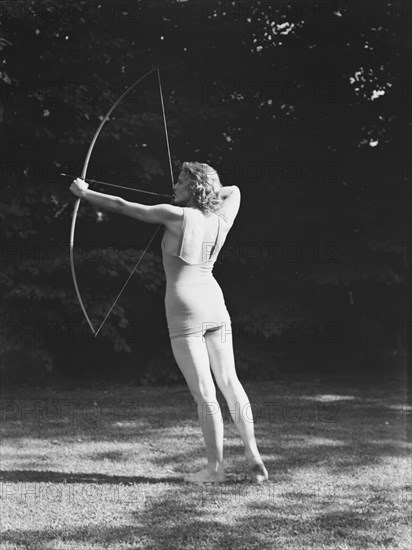 Chase, Diana, Miss, doing archery, 1933 June 22. Creator: Arnold Genthe.