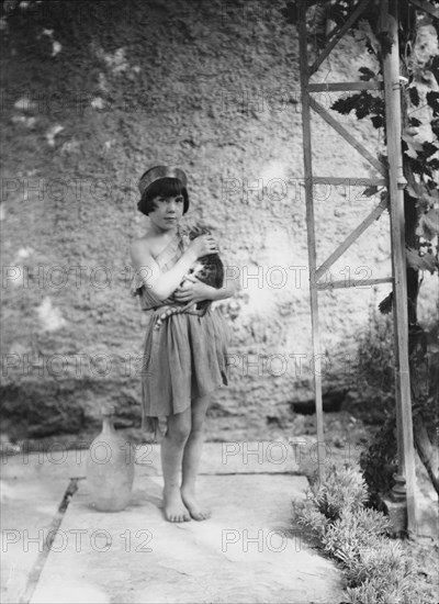 Kanellos child in dance costume holding a cat, 1929 Creator: Arnold Genthe.