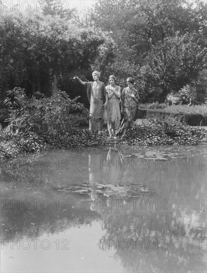 People wearing masks made by W.T. Benda, 1925 Sept. 20. Creator: Arnold Genthe.