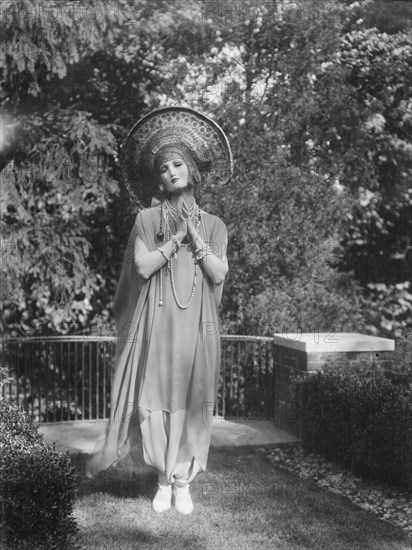 Person wearing a mask made by W.T. Benda, 1925 Sept. 20. Creator: Arnold Genthe.