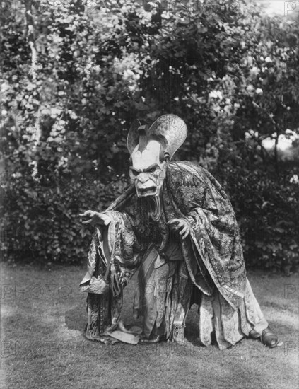 Person wearing a mask made by W.T. Benda, 1925 Sept. 20. Creator: Arnold Genthe.