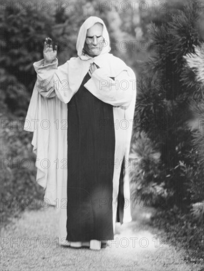 Person wearing a mask made by W.T. Benda, 1925 Sept. 20. Creator: Arnold Genthe.