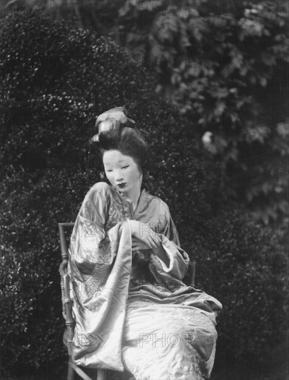 Person wearing a mask made by W.T. Benda, 1925 Sept. 20. Creator: Arnold Genthe.