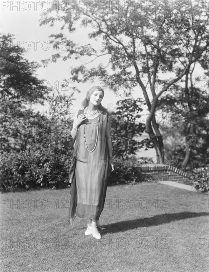 Person wearing a mask made by W.T. Benda, 1925 Sept. 20. Creator: Arnold Genthe.