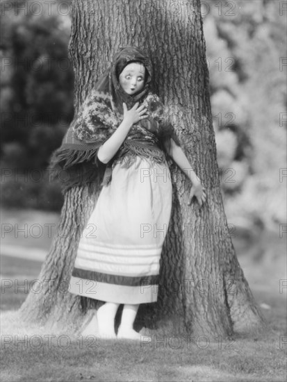 Person wearing a mask made by W.T. Benda, 1925 Sept. 20. Creator: Arnold Genthe.