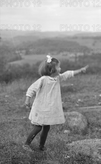 MacKaye, Percy, daughter of, standing outdoors, 1913 Sept. Creator: Arnold Genthe.