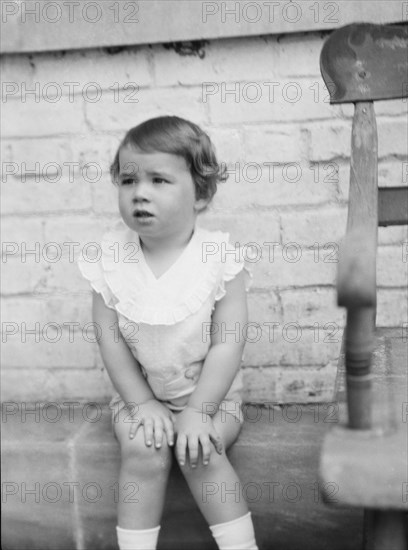 Moseley, F.S., Mr., child of, seated outdoors, 1930 May 24. Creator: Arnold Genthe.