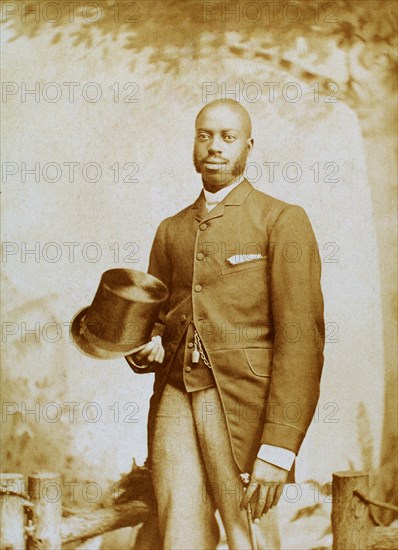 Studio portrait of man with top hat and cane, c1880-c1889. Creator: George E. Curtis.