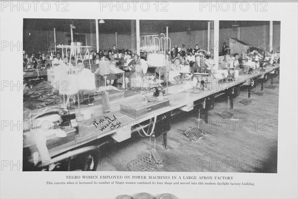 Negro women employed on power machines in a large apron factory, 1922. Creator: Unknown.