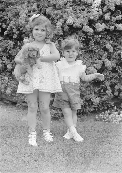 Javits, Benjamin, children of, with dog, standing outdoors, 1933 July. Creator: Arnold Genthe.