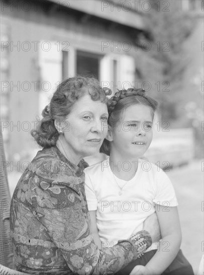 Churchill, Mrs., with child Orrin, seated outdoors, not before 1932 Mar. Creator: Arnold Genthe.