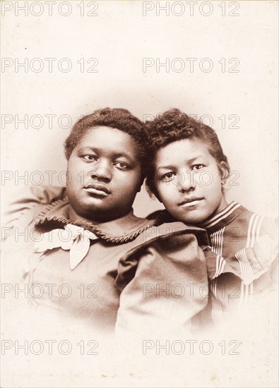 Studio portrait of two young women, heads touching, c1890-c1899. Creators: R. D. Cochran, Unknown.