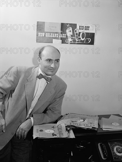 Portrait of George Avakian in his office or home, New York, N.Y.(?), 1938. Creator: William Paul Gottlieb.