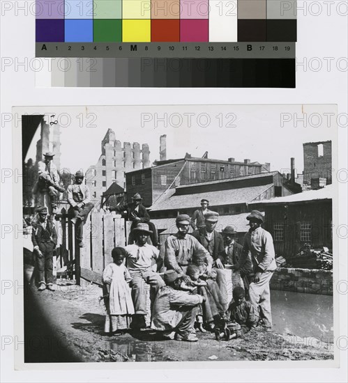 Group of freedmen, including children, gathered by a canal in Richmond, Virginia, c1865. Creator: Unknown.