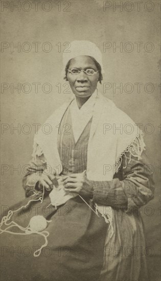 Portrait of abolitionist Sojourner Truth, sitting with yarn and knitting needles, 1864. Creator: JH Preiter.