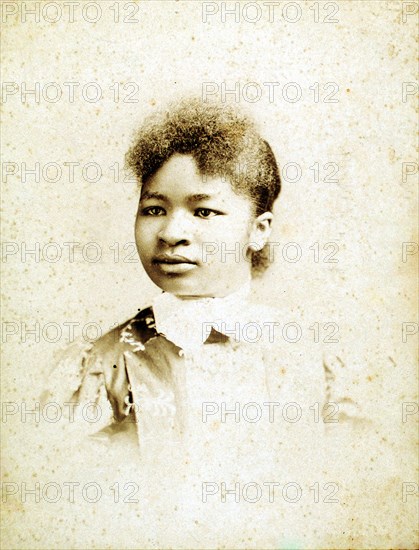 Studio portrait of young woman, head turned to her right, (1880-1900?). Creators: Stanton & Burdick, Unknown.