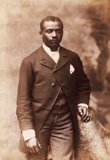 Studio portrait of a man dressed in jacket, vest, tie and striped pants, c1880-c1889. Creator: Alexander Hesler.