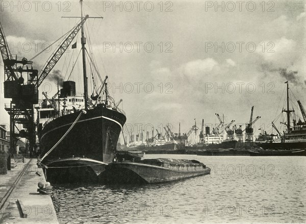 Merchants Bring In Wares By Ships from Every Nation Vessels alongside the Quays...', 1937. Creator: J Dixon-Scott.