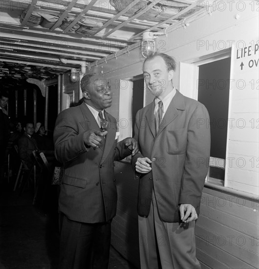 Portrait of Rudi Blesh and Baby Dodds, Riverboat on the Hudson, N.Y., ca. July 1947. Creator: William Paul Gottlieb.