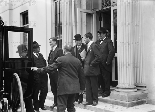 Franklin K. Lane, With Paper in Hand, in Crowd of Newsmen, 1914. Creator: Harris & Ewing.