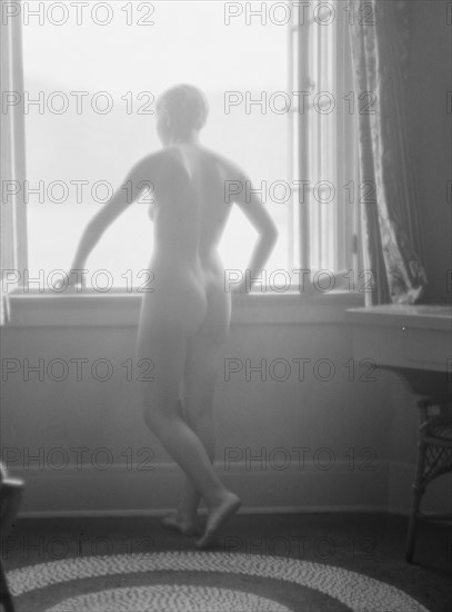 Lee, Margaret, Miss, standing at a window, 1927 Creator: Arnold Genthe.