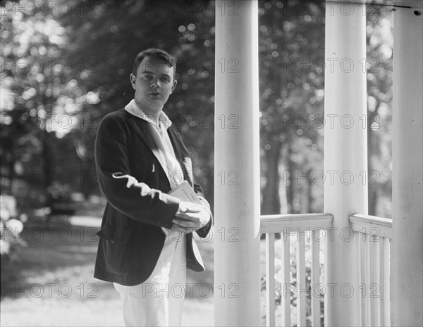 Leslie, Margeurite, friend of, standing on a porch, 1917 Aug. 18. Creator: Arnold Genthe.