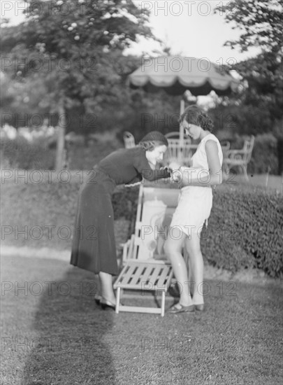 Rossbach, Miss, holding puppies, with another woman, 1932 June 30. Creator: Arnold Genthe.