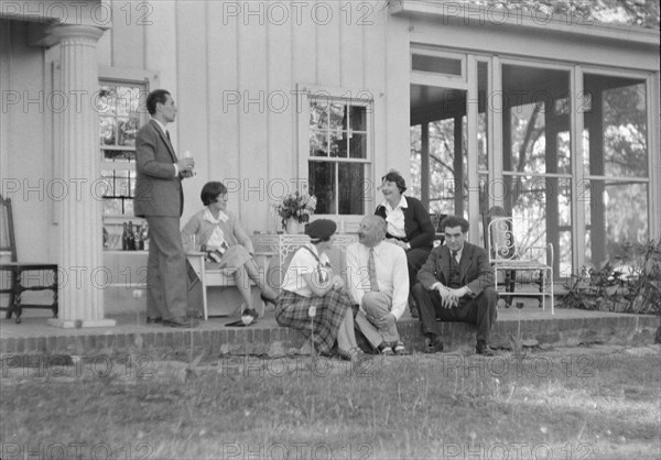 Rothbart, Albert, Mr., group, seated on a porch, between 1920 and 1935. Creator: Arnold Genthe.
