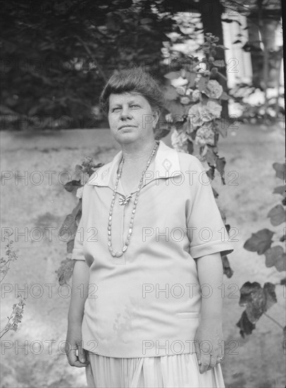 Unidentified woman, possibly Mrs. Cosgrave, standing outdoors, not before 1917. Creator: Arnold Genthe.