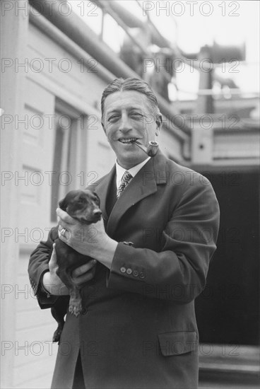 Von Lueckner, Felix, Count, with dog, standing outdoors, 1931 June 5. Creator: Arnold Genthe.