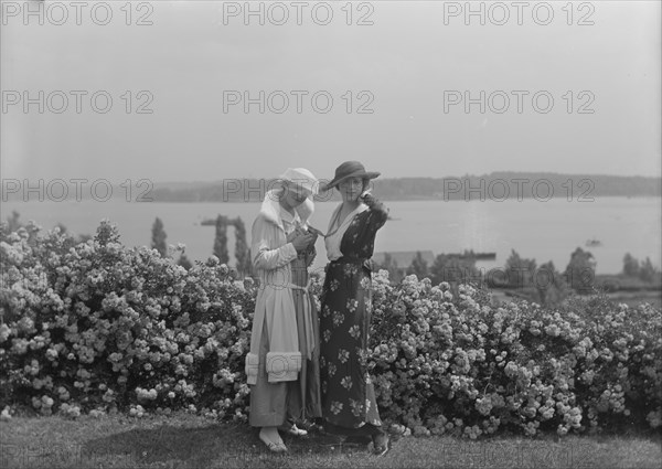Viola Kraus and Helen Freeman standing outdoors, 1915 June. Creator: Arnold Genthe.