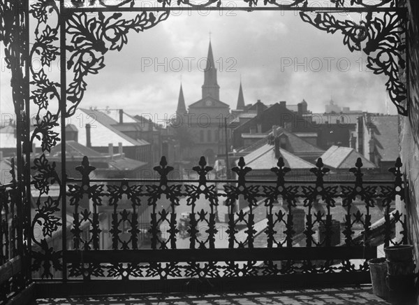 A vista through iron lace, New Orleans, between 1920 and 1926. Creator: Arnold Genthe.