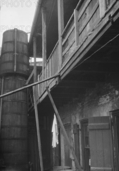 Courtyard with cistern, New Orleans, between 1920 and 1926. Creator: Arnold Genthe.