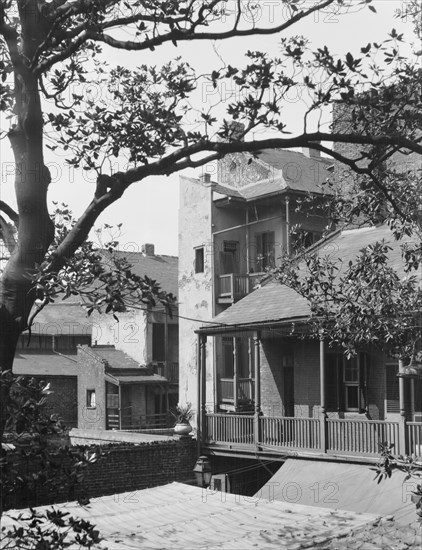 Courtyard balconies and upper levels of houses, New Orleans, between 1920 and 1926. Creator: Arnold Genthe.