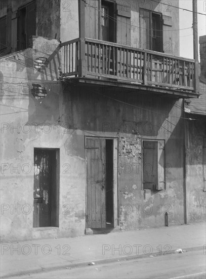 Facade of a multi-story house in the French Quarter, New Orleans, between 1920 and 1926. Creator: Arnold Genthe.