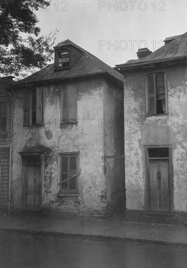 Facades of two-story houses, [Alexander Peronneau Tenements, 141 Church Street..., c1920-1926. Creator: Arnold Genthe.