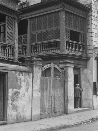 Multi-story house behind gated wall, New Orleans or Charleston, South Carolina, c1920-1926. Creator: Arnold Genthe.