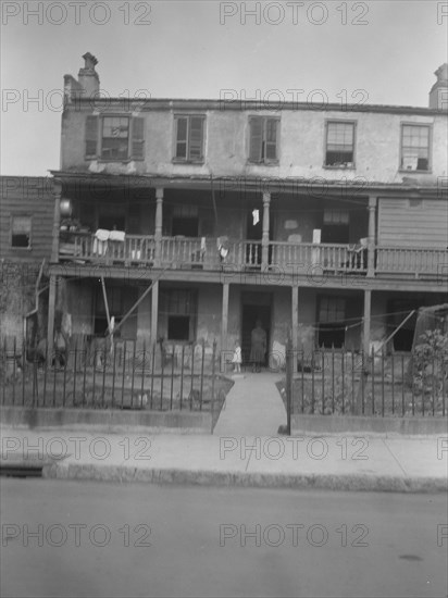 Multi-story housing, New Orleans or Charleston, South Carolina, between 1920 and 1926. Creator: Arnold Genthe.