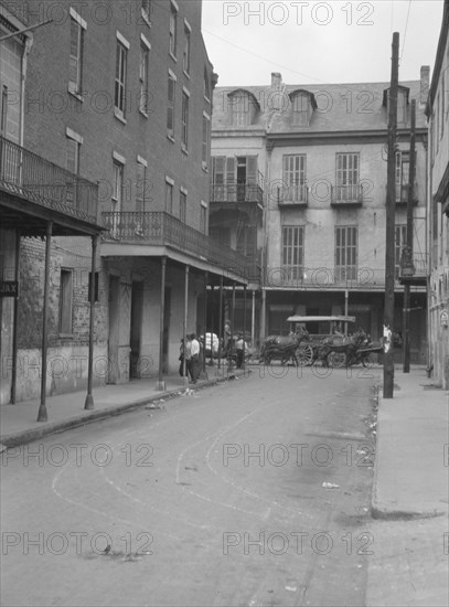 View down a street, New Orleans, between 1920 and 1926. Creator: Arnold Genthe.