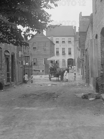 Street scene - looking north on Bedons Alley to Elliott Street; with horse and wagon..., c1920-1926. Creator: Arnold Genthe.