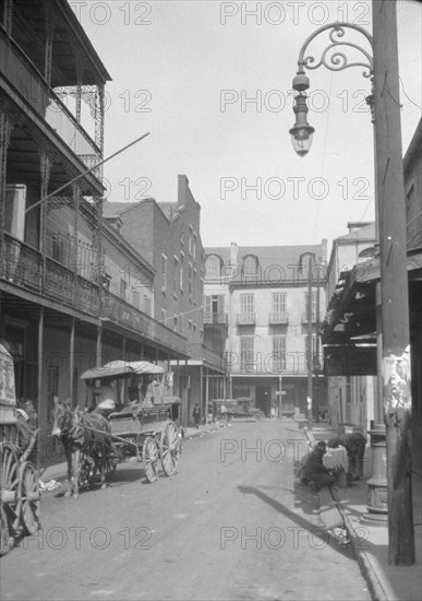 View down a street, New Orleans or Charleston, South Carolina, between 1920 and 1926. Creator: Arnold Genthe.