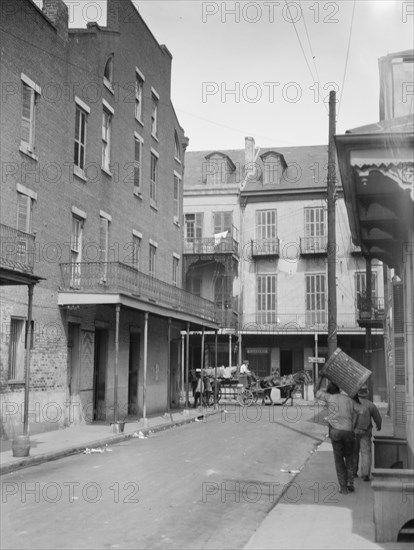 View down a street, New Orleans, between 1920 and 1926. Creator: Arnold Genthe.