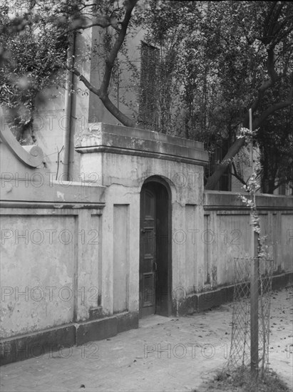 Wall with gate enclosing a building, New Orleans or Charleston, South Carolina, c1920-1926. Creator: Arnold Genthe.