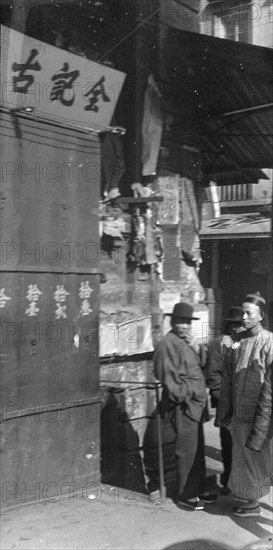 Two men standing on a sidewalk, Chinatown, San Francisco, between 1896 and 1906. Creator: Arnold Genthe.