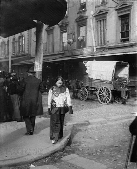 A woman in holiday attire, Chinatown, San Francisco, between 1896 and 1906. Creator: Arnold Genthe.